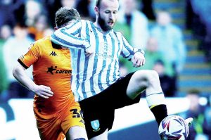 MASTER CRAFTSMAN: Barry Bannan in typical action for Sheffield Wednesday and, Inset, celebrating promotion with the Owls in 2023 PICTURE: Alamy