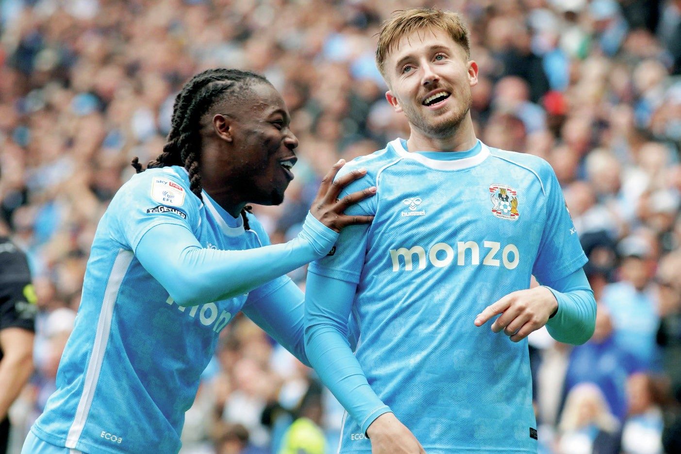Coventry City’s Brandon Thomas-Asante, left, pushes Josh Eccles forward after his part in the second goal