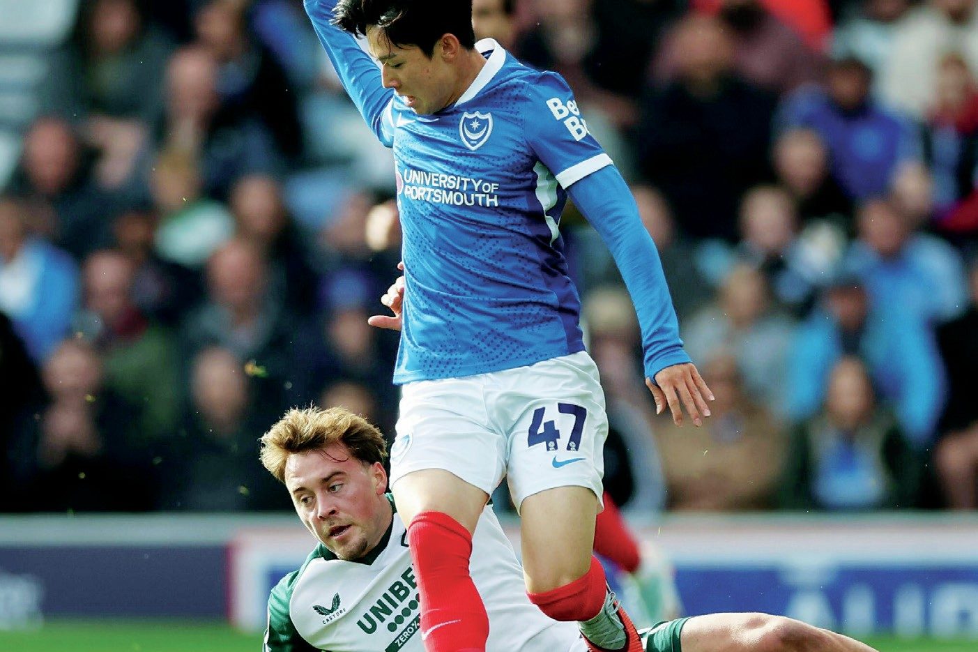 Scorer Yang Min-hyeok rides a challenge from Middlesbrough’s Aidan Morris in action