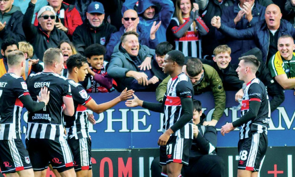 Grimsby Town players and fans enjoy their second goal