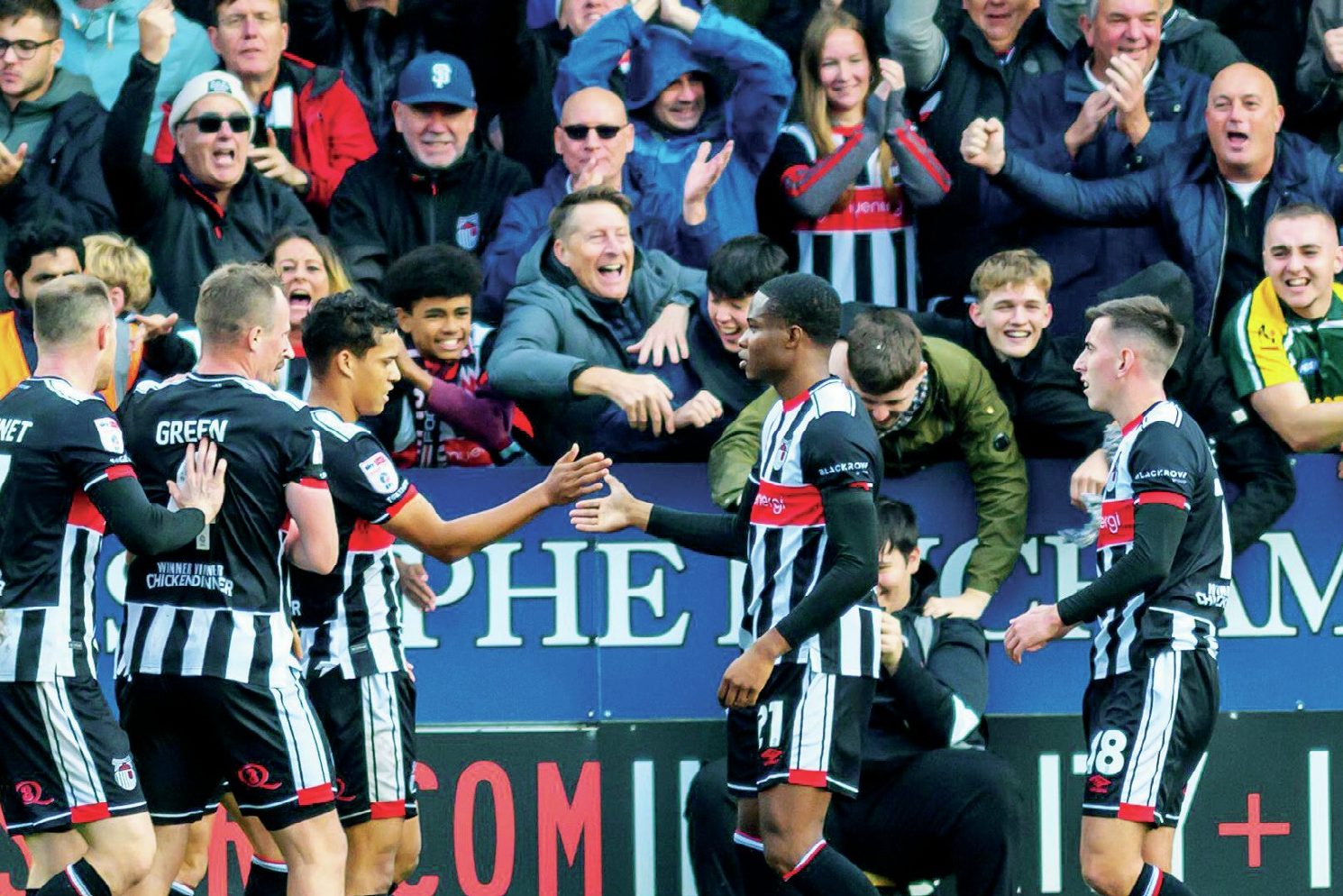 Grimsby Town players and fans enjoy their second goal