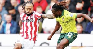 Stoke City goalscorer Sorba Thomas takes on Wrexham’s Issa Kabore before his cross flies towards the net