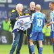 Sheffield Wednesday fans talk to Owls skipper Barry Bannan after invading the pitch to protest against owner Dejphon Chansiri
