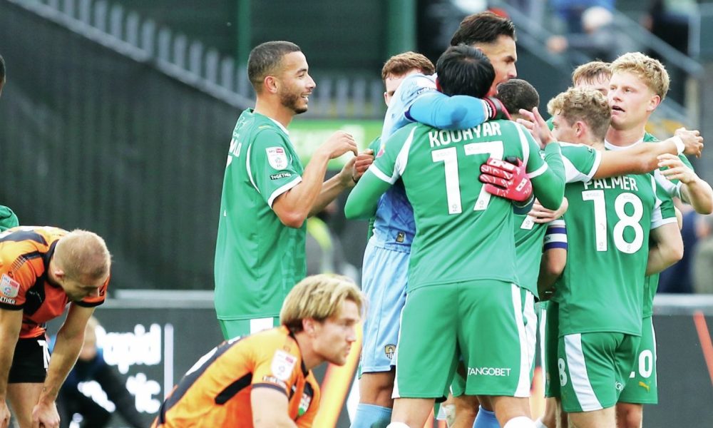 Notts County players celebrate their injury-time win as Barnet look on dejected