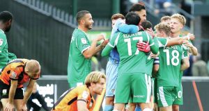 Notts County players celebrate their injury-time win as Barnet look on dejected