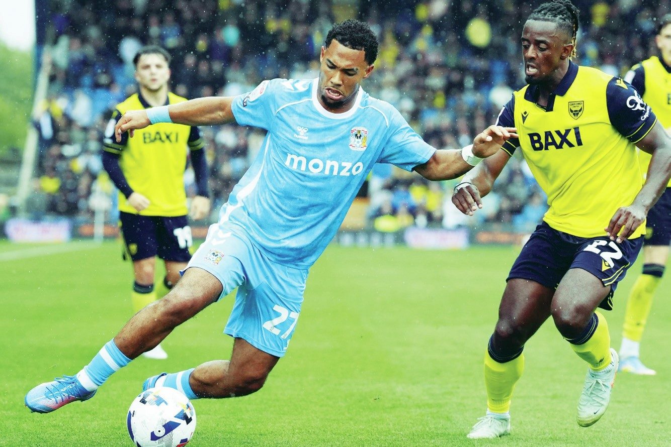 Coventry City’s Milan van Ewijk takes on Oxford United’s Greg Leigh