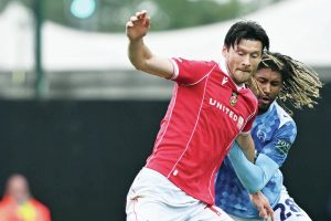 Wrexham’s Kieffer Moore battles with Derby County’s Dion Sanderson