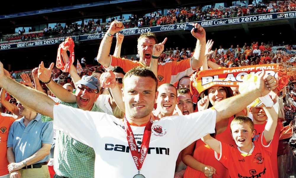 Ian Evatt celebrates with elated Blackpool fans after winning promotion to the Premier League in 2010