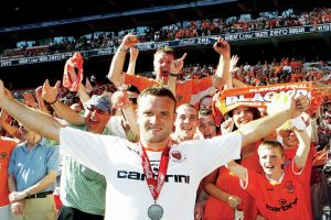 Ian Evatt celebrates with elated Blackpool fans after winning promotion to the Premier League in 2010