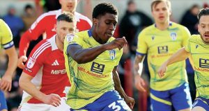 Colchester United forward Micah Mbick shoots at goal