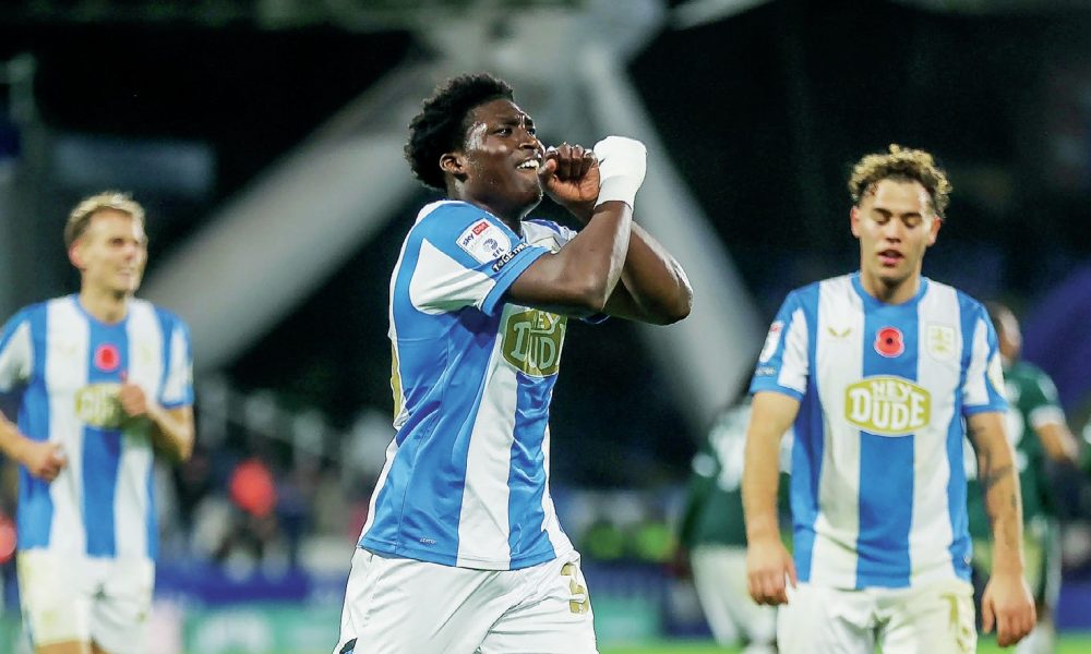 Cameron Ashia celebrates scoring Huddersfield Town’s third goal