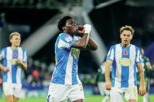 Cameron Ashia celebrates scoring Huddersfield Town’s third goal