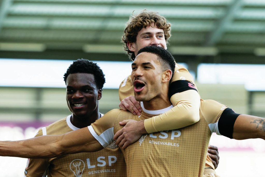 Omar Sowunmi celebrates with his team-mates after scoring Bromley’s opener
