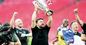 Russell Martin lifts the Championship play-off trophy in front of the Southampton fans