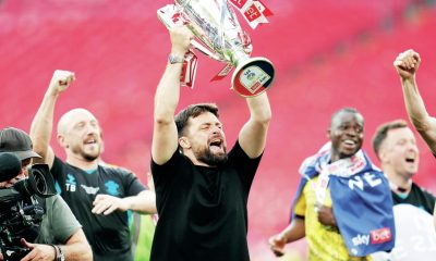 Russell Martin lifts the Championship play-off trophy in front of the Southampton fans