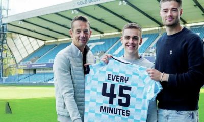 Millwall fan William Kilgannon is flanked by former captain Paul Robinson, left, and keeper Lukas Jensen
