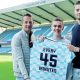 Millwall fan William Kilgannon is flanked by former captain Paul Robinson, left, and keeper Lukas Jensen