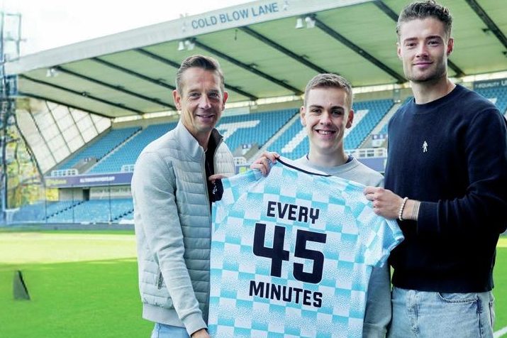Millwall fan William Kilgannon is flanked by former captain Paul Robinson, left, and keeper Lukas Jensen