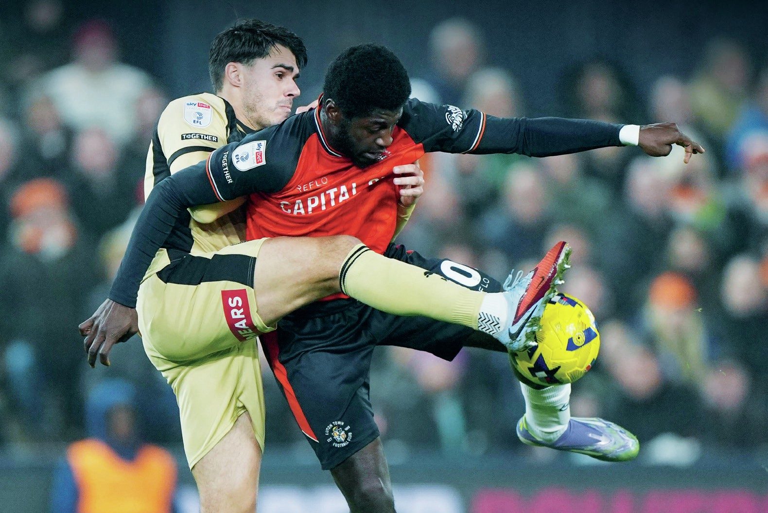 Rotherham’s Reece James, left, tangles with Luton’s Gideon Kodua