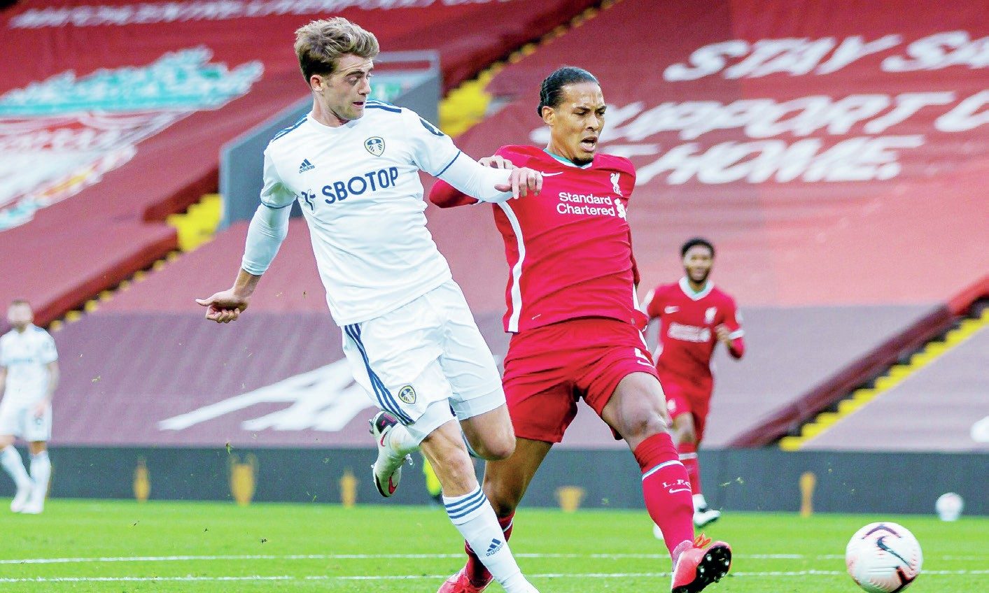 Patrick Bamford, left, scores for Leeds against Liverpool in 2020 despite the attentions of Virgil van Dijk