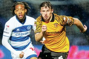 Hull City’s Charlie Hughes, right, attempts to break away from QPR match-winner Rumarn Burrell