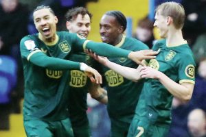 Lasse Sorensen, right, celebrates scoring the Terriers’ third with his teammates