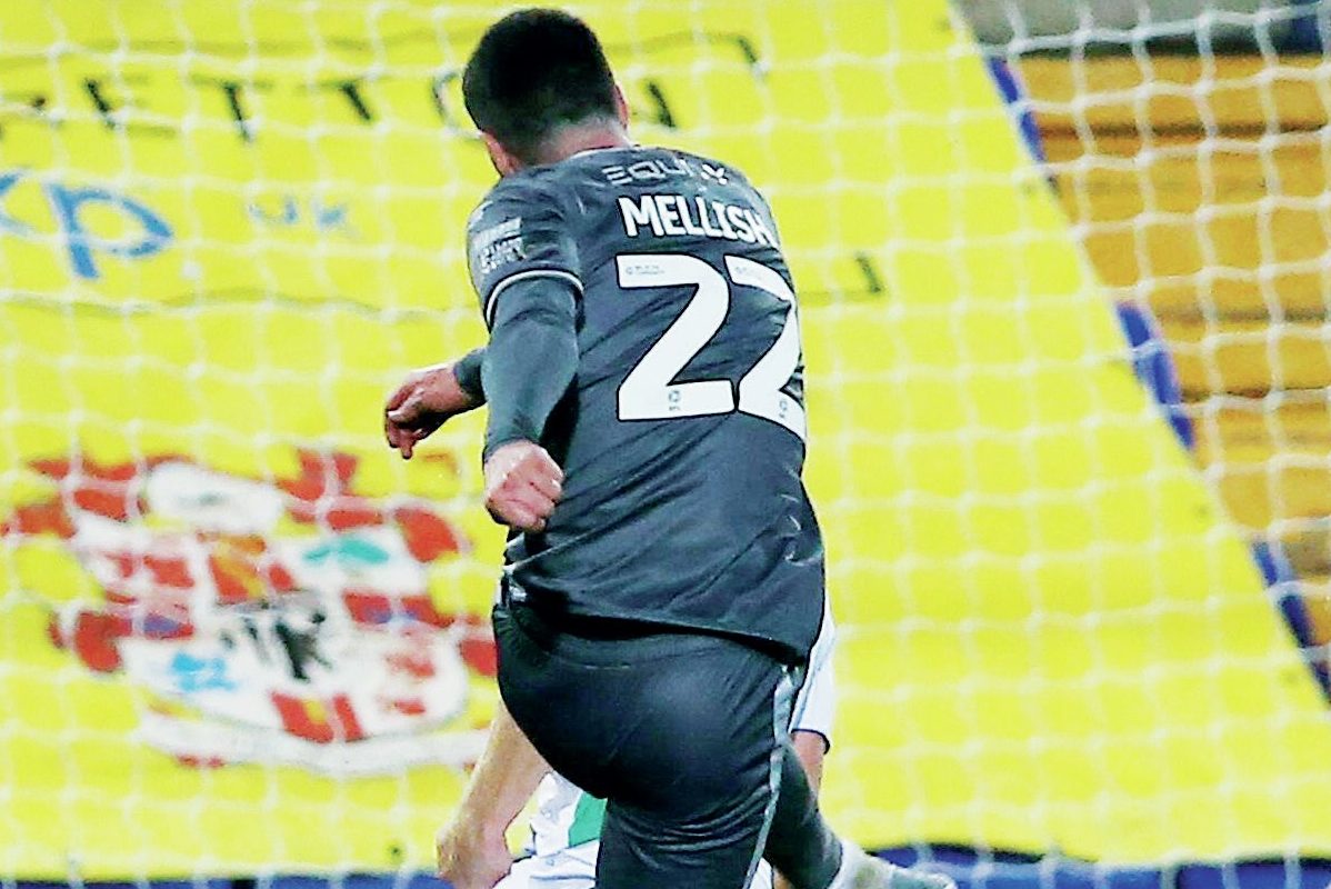 Milton Keynes Dons’ Jon Mellish fires in their first goal to reduce the deficit