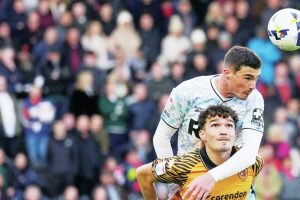 Lloyd Jones wins a header against Hull’s Kyle Joseph