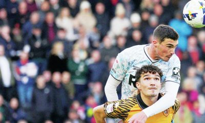 Lloyd Jones wins a header against Hull’s Kyle Joseph