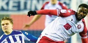 Wigan’s Matt Smith, left, makes a challenge on Boro’s Beryly Lubala