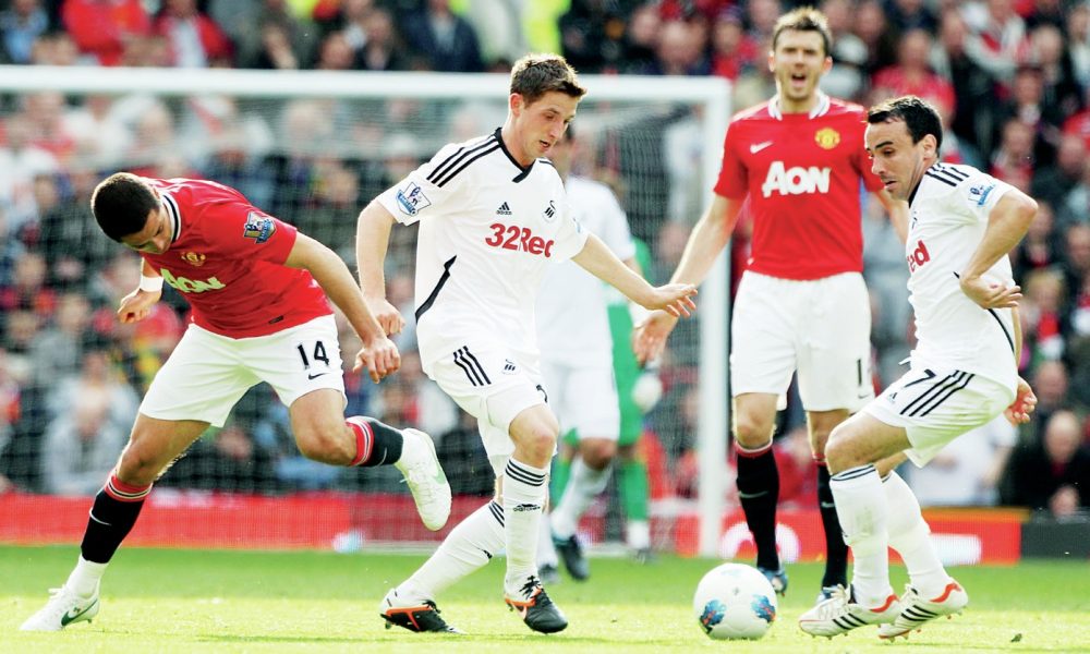 Swansea’s Joe Allen, centre, and Leon Britton, right, in possession against Manchester United
