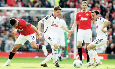 Swansea’s Joe Allen, centre, and Leon Britton, right, in possession against Manchester United