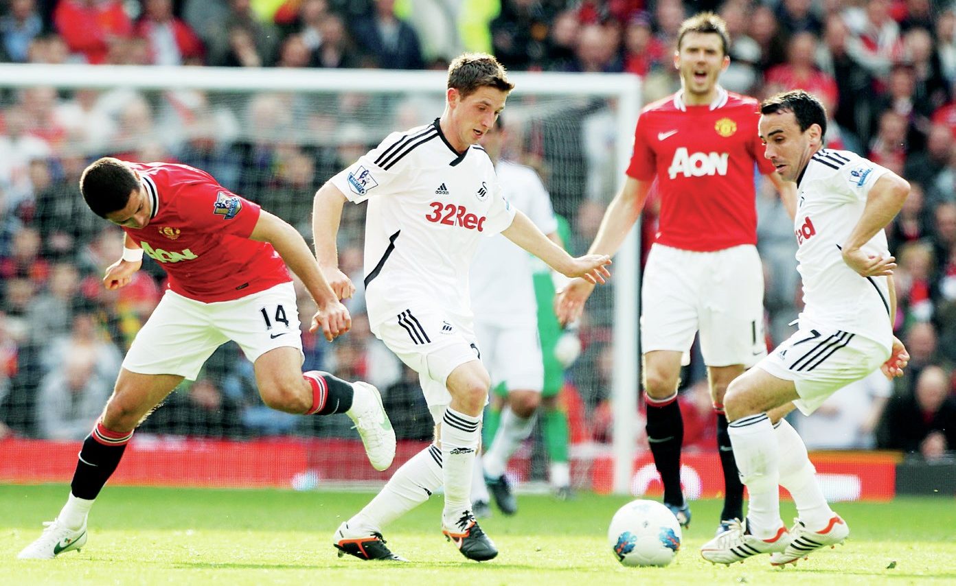 Swansea’s Joe Allen, centre, and Leon Britton, right, in possession against Manchester United