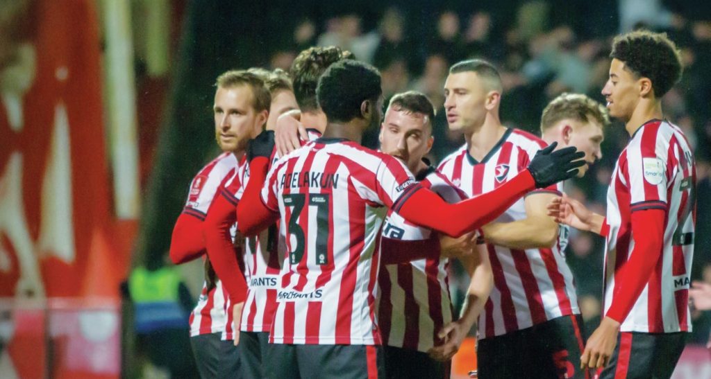 Cheltenham Town celebrate their fourth goal