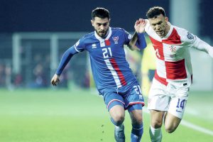 The Faroe Islands’ Geza Turi, left, competes with Croatia’s Ivan Perisic