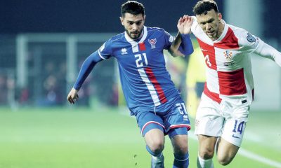The Faroe Islands’ Geza Turi, left, competes with Croatia’s Ivan Perisic