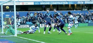 Koki Saito, right, watches on as the ball bounces off him and into the net to put QPR ahead early on