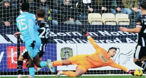 Notts County keeper Kelle Roos saves well from Daniel Kanu