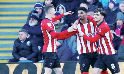 Reeco Hackett celebrates scoring Lincoln City’s first goal