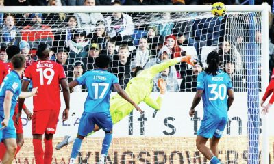 Leyton Orient keeper Tommy Simkin makes a flying save before half-time