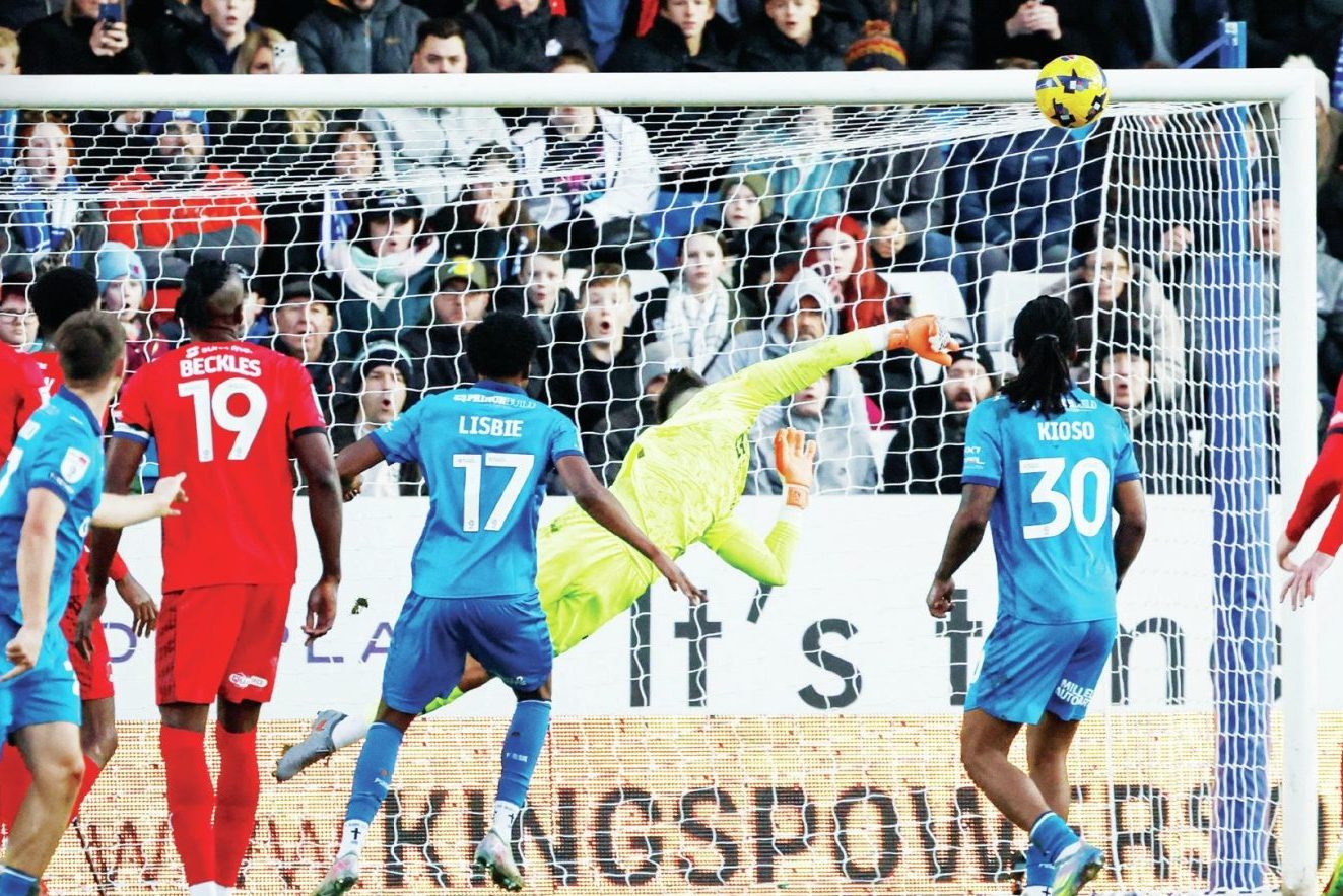 Leyton Orient keeper Tommy Simkin makes a flying save before half-time