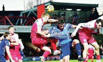 Barrow’s Niall Canavan is sandwiched as he challenges for a header