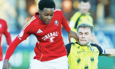 Salford City’s Kallum Cesay is tackled by Harrogate Town’s Conor McAleny