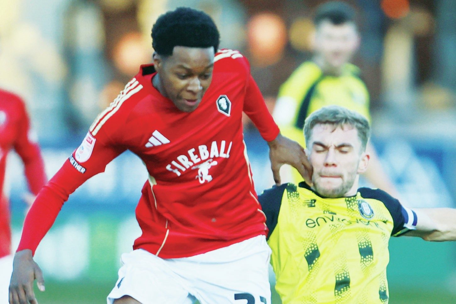 Salford City’s Kallum Cesay is tackled by Harrogate Town’s Conor McAleny