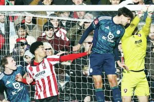 Cheltenham goalkeeper Joe Day punches clear under pressure from Leicester’s Ben Nelson