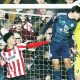 Cheltenham goalkeeper Joe Day punches clear under pressure from Leicester’s Ben Nelson