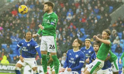 Stockport County midfielder Oliver Norwood rises high and heads clear