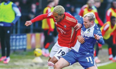 Bristol Rovers’ Luke Thomas, right, battles with Salford City’s Haji Mnoga