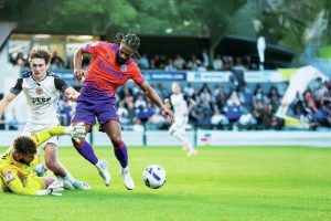 Gillingham’s Garath McCleary earns a penalty against Bromley