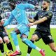 Coventry City attacker Romain Esse is challenged by Oxford United’s Jamie McDonnell, left, and Brodie Spencer